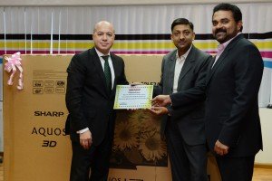 Mr. Natour receiving his prize and certificate from Mr. Rao and Mr. Samuel at the Sharp office